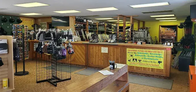 Inside the shop: rental counter, skis and boots
